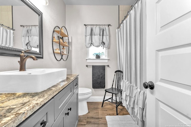 full bath with vanity, baseboards, toilet, and wood finished floors
