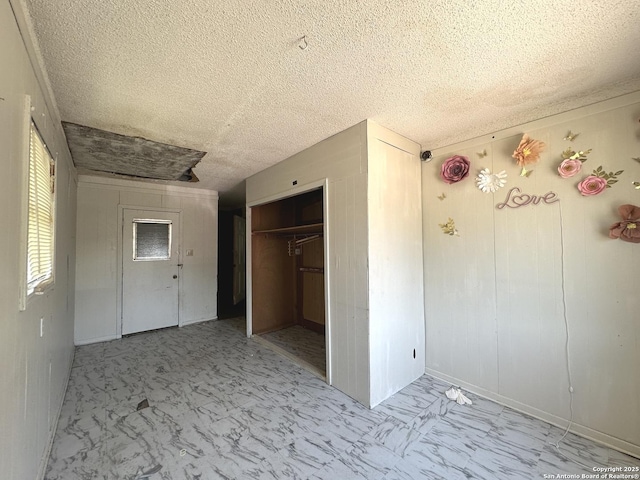 4535 Lark, San Antonio, TX 78228 - unfurnished bedroom with marble finish flooring, a textured ceiling, and a closet