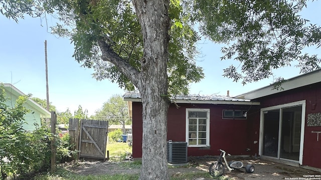 4535 Lark, San Antonio, TX 78228 - back of property featuring central air condition unit, metal roof, and a gate