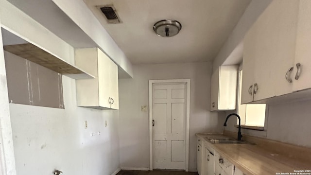 4535 Lark, San Antonio, TX 78228 - kitchen featuring a sink, light countertops, and white cabinets