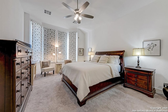 bedroom featuring visible vents, a ceiling fan, and light carpet