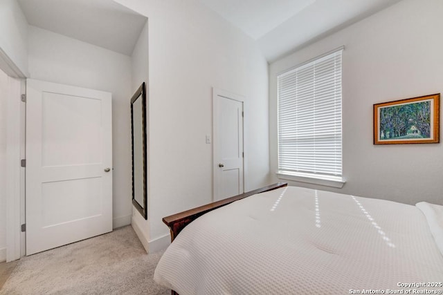 carpeted bedroom featuring baseboards
