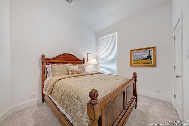 bedroom with baseboards, visible vents, and light colored carpet