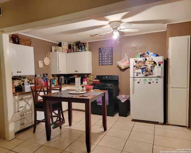 4831 Hemphill Dr, San Antonio, TX 78228 - kitchen featuring crown molding, ceiling fan, freestanding refrigerator, black range with gas stovetop, and white cabinetry