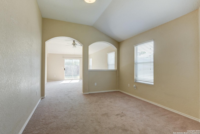 7614 Copper Dawn, Converse, TX 78109 - spare room with healthy amount of natural light, carpet, arched walkways, a textured wall, and vaulted ceiling