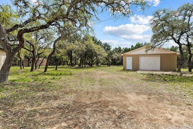 2501 Fischer Store, Wimberley, TX 78676 - view of yard featuring a detached garage, an outbuilding, and driveway