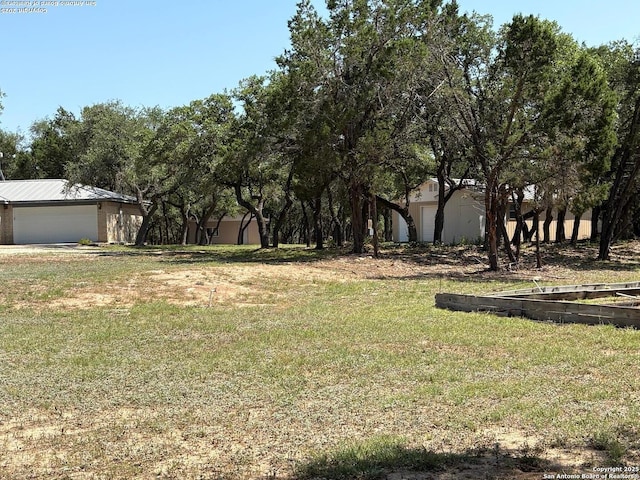 2501 Fischer Store, Wimberley, TX 78676 - view of green lawn featuring a garage
