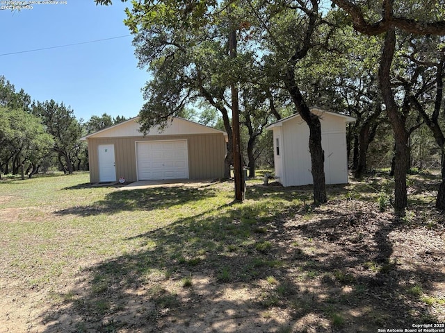 2501 Fischer Store, Wimberley, TX 78676 - view of green lawn featuring an outdoor structure and a garage