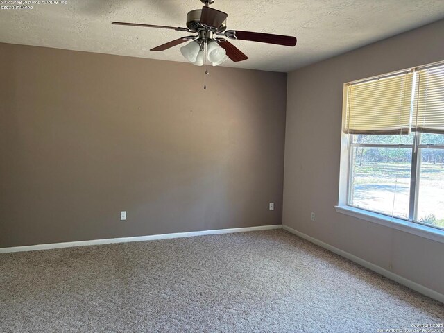 2501 Fischer Store, Wimberley, TX 78676 - carpeted empty room with a textured ceiling, baseboards, and ceiling fan
