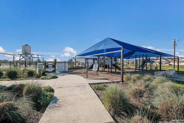 view of home's community featuring fence and playground community