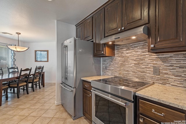 411 W Greenbriar Dr, Granite Shoals, TX 78654 - kitchen featuring dark brown cabinetry, appliances with stainless steel finishes, under cabinet range hood, visible vents, and decorative backsplash