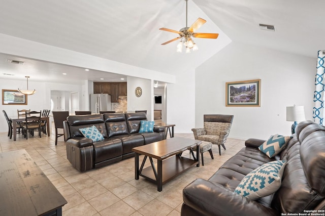 411 W Greenbriar Dr, Granite Shoals, TX 78654 - living room with light tile patterned floors, lofted ceiling, visible vents, and a ceiling fan