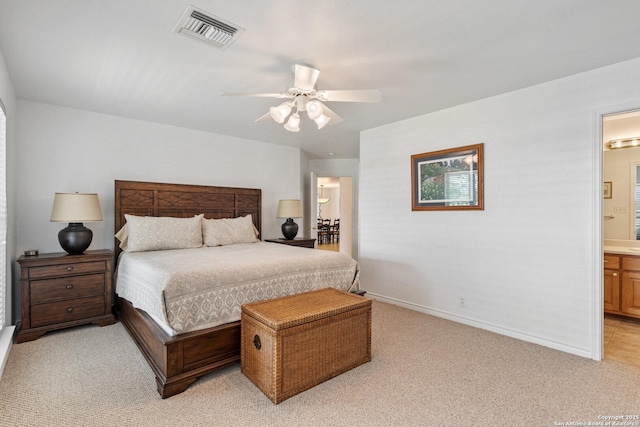 411 W Greenbriar Dr, Granite Shoals, TX 78654 - bedroom with baseboards, ensuite bath, light colored carpet, visible vents, and ceiling fan