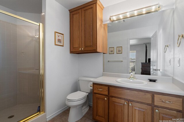 411 W Greenbriar Dr, Granite Shoals, TX 78654 - full bathroom featuring vanity, a wood stove, toilet, tile patterned floors, and a stall shower