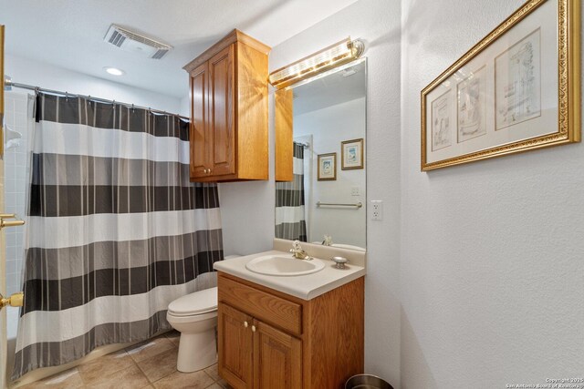411 W Greenbriar Dr, Granite Shoals, TX 78654 - bathroom with a shower with shower curtain, toilet, vanity, tile patterned flooring, and visible vents