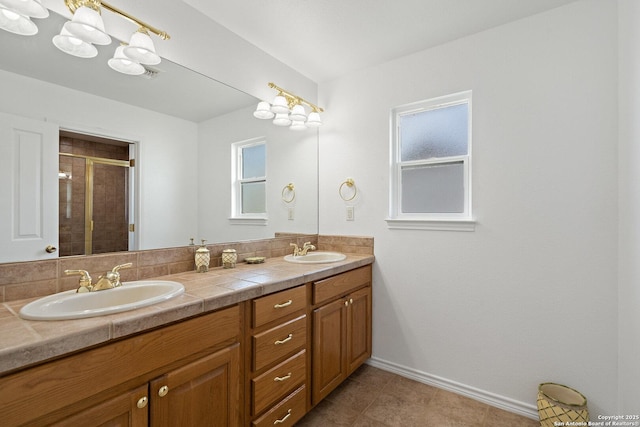 411 W Greenbriar Dr, Granite Shoals, TX 78654 - full bathroom with double vanity, a sink, baseboards, and a shower stall