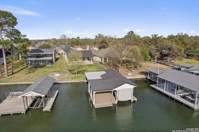 411 W Greenbriar Dr, Granite Shoals, TX 78654 - dock area with boat lift, a residential view, a water view, and a yard