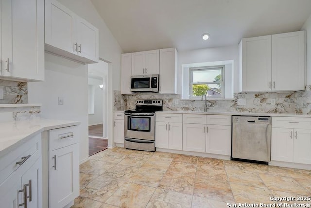 kitchen with light countertops, white cabinets, a sink, and appliances with stainless steel finishes