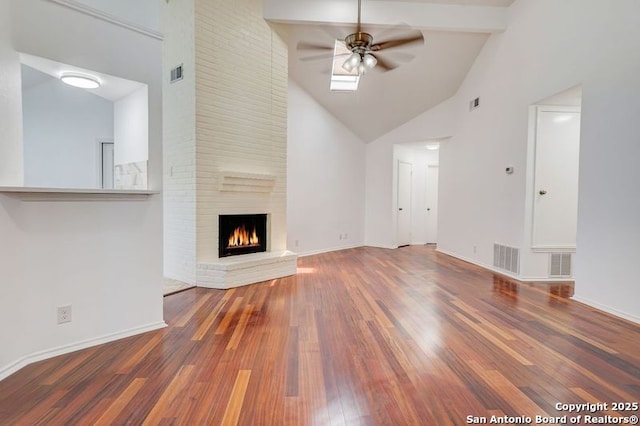 unfurnished living room featuring wood finished floors, visible vents, and ceiling fan