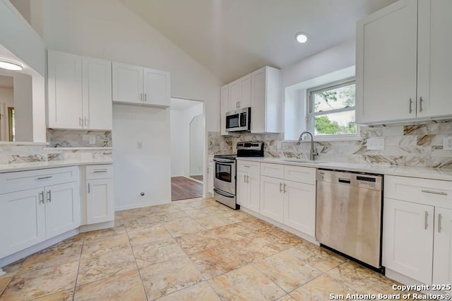 kitchen with a sink, white cabinetry, light countertops, and appliances with stainless steel finishes