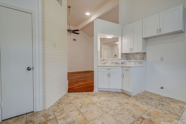 kitchen featuring light countertops, vaulted ceiling with beams, tasteful backsplash, white cabinets, and ceiling fan