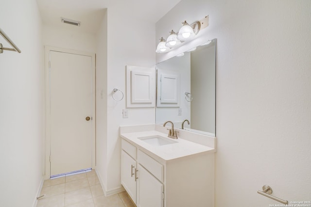 bathroom featuring baseboards, visible vents, tile patterned floors, and vanity