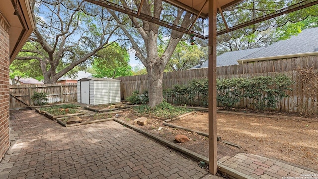 view of patio / terrace with a fenced backyard, an outbuilding, and a storage shed
