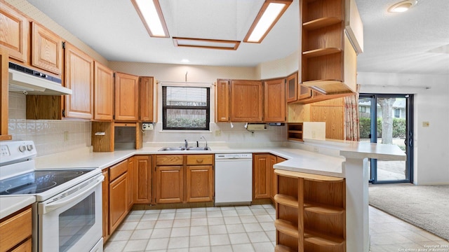 kitchen with white appliances, under cabinet range hood, a sink, and open shelves