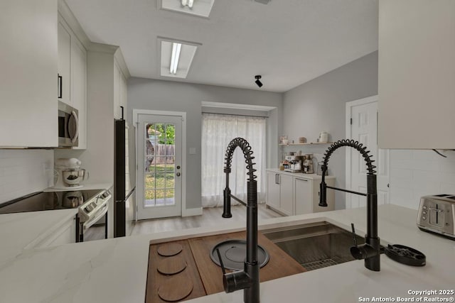 5038 Fawn Lake Dr, San Antonio, TX 78244 - workout room with a sink and wood finished floors