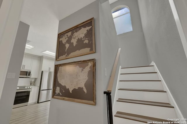 5038 Fawn Lake Dr, San Antonio, TX 78244 - stairway featuring wood finished floors
