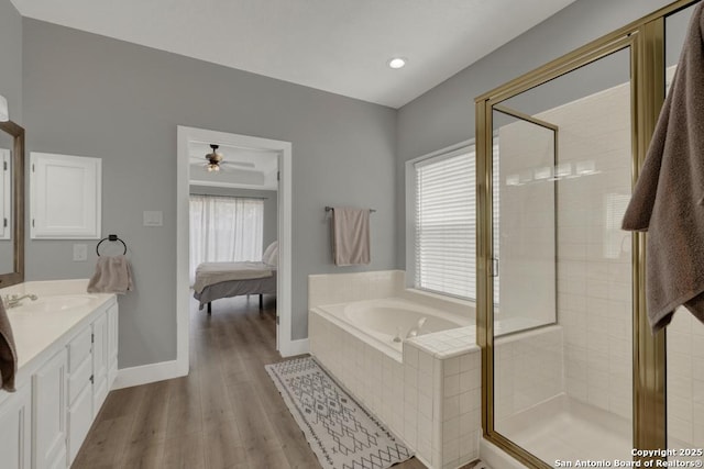 5038 Fawn Lake Dr, San Antonio, TX 78244 - bathroom featuring vanity, a bath, a shower stall, a ceiling fan, and wood finished floors