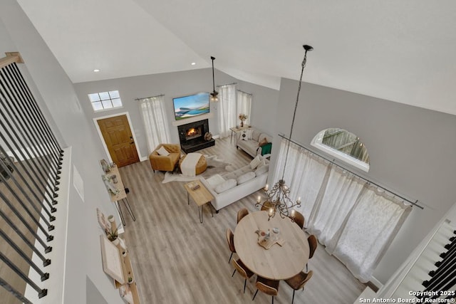 5038 Fawn Lake Dr, San Antonio, TX 78244 - living area with high vaulted ceiling, stairway, a warm lit fireplace, wood finished floors, and baseboards