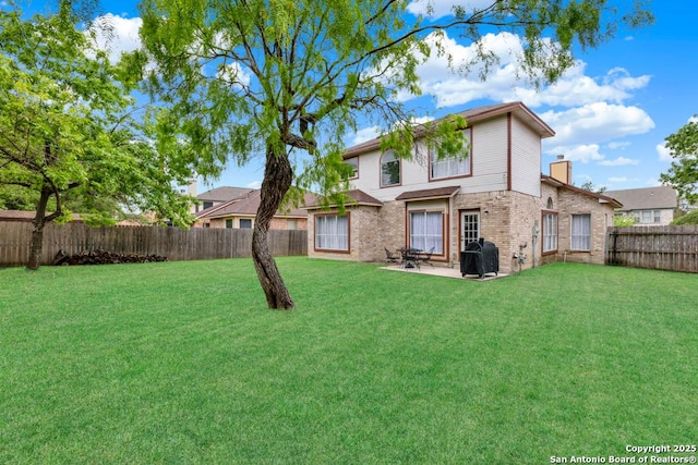 5038 Fawn Lake Dr, San Antonio, TX 78244 - rear view of property with a fenced backyard, brick siding, a patio, and a lawn