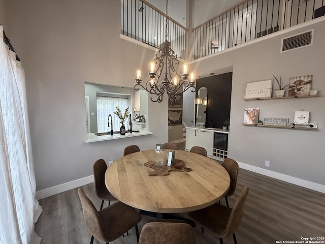 5038 Fawn Lake Dr, San Antonio, TX 78244 - dining space featuring baseboards, visible vents, an inviting chandelier, and wood finished floors