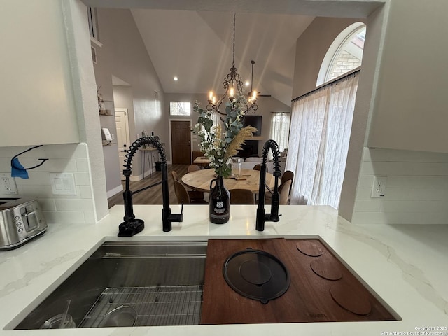 5038 Fawn Lake Dr, San Antonio, TX 78244 - room details featuring tasteful backsplash, decorative light fixtures, light stone counters, and a chandelier