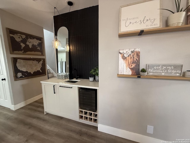 5038 Fawn Lake Dr, San Antonio, TX 78244 - bar featuring a sink, baseboards, and dark wood finished floors