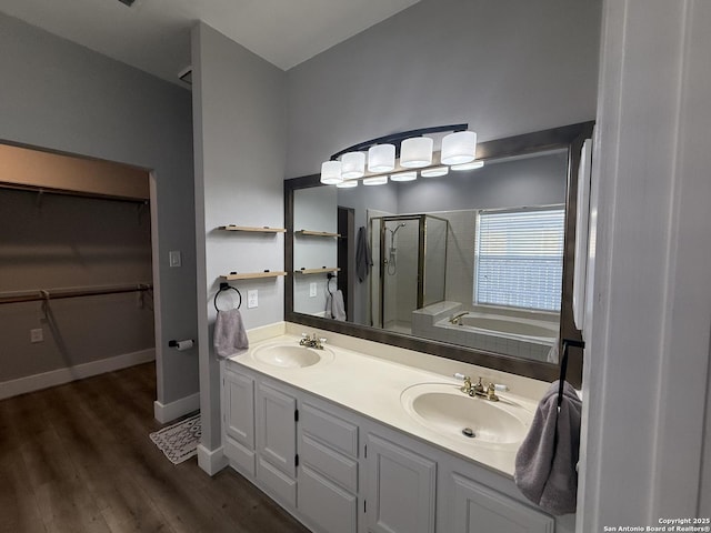 5038 Fawn Lake Dr, San Antonio, TX 78244 - bathroom with double vanity, a sink, a stall shower, and wood finished floors
