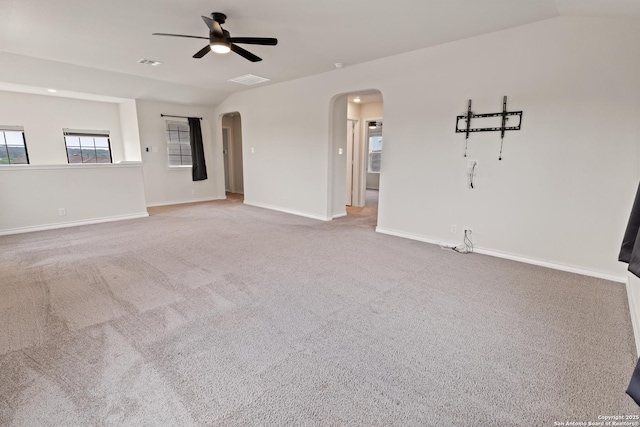 147 Festive Coquette, San Antonio, TX 78253 - unfurnished living room featuring visible vents, ceiling fan, arched walkways, carpet floors, and baseboards