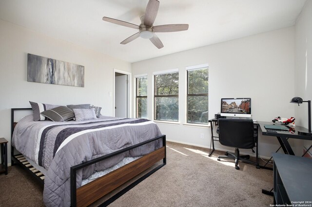 7102 Valley Trl, San Antonio, TX 78250 - carpeted bedroom featuring baseboards and a ceiling fan