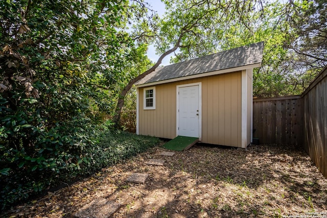 view of shed featuring fence