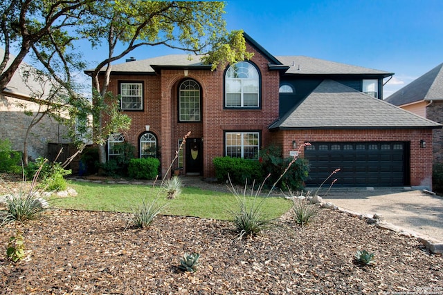 19423 Camino Rdg, San Antonio, TX 78258 - view of front of home with a garage, a shingled roof, brick siding, and concrete driveway