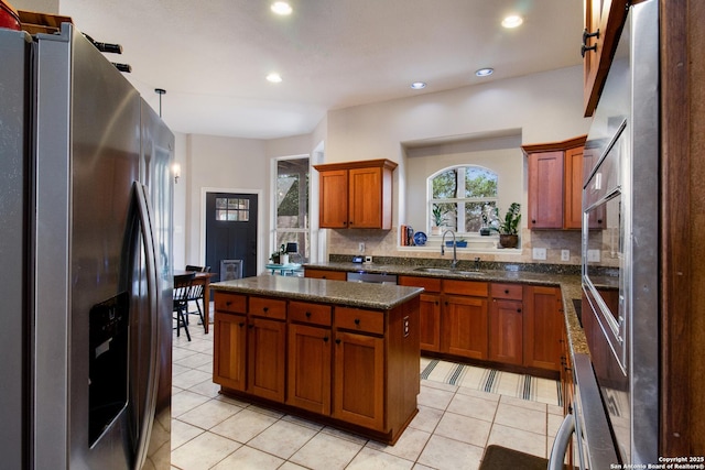 19423 Camino Rdg, San Antonio, TX 78258 - kitchen featuring stainless steel appliances, a sink, backsplash, light tile patterned floors, and recessed lighting