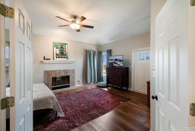 19423 Camino Rdg, San Antonio, TX 78258 - bedroom featuring wood finished floors, a tiled fireplace, and ceiling fan