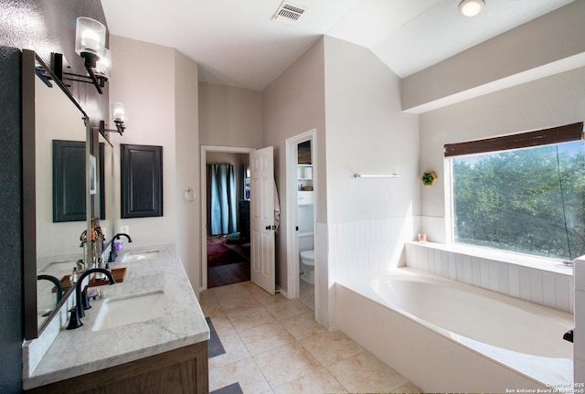 19423 Camino Rdg, San Antonio, TX 78258 - full bath featuring toilet, a garden tub, vaulted ceiling, double vanity, and tile patterned flooring