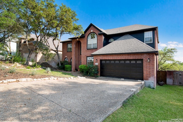 19423 Camino Rdg, San Antonio, TX 78258 - traditional-style house with concrete driveway, an attached garage, brick siding, a shingled roof, and fence
