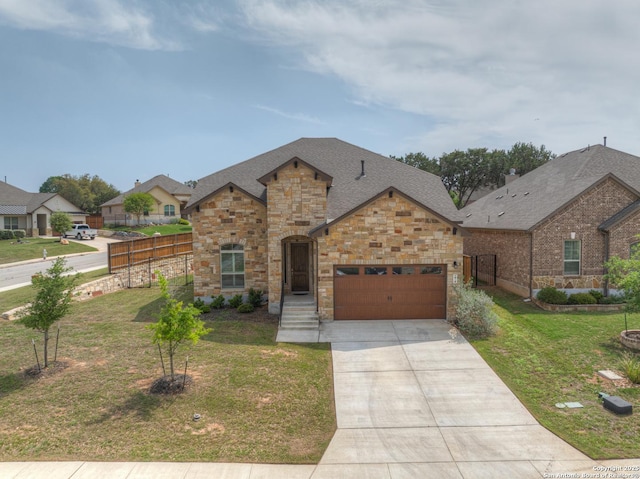 view of front of house with stone siding, an attached garage, concrete driveway, a front yard, and roof with shingles