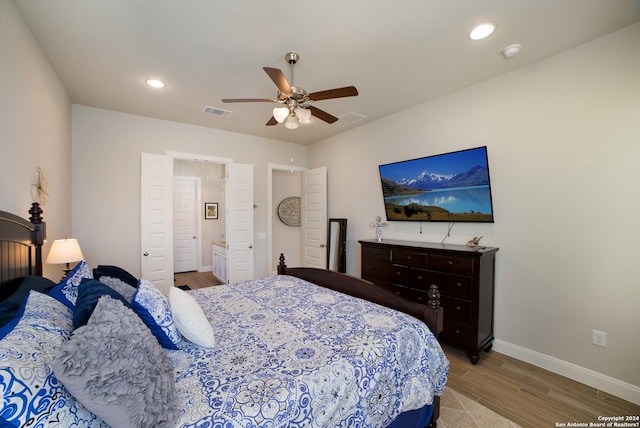 bedroom featuring a ceiling fan, wood finished floors, baseboards, visible vents, and recessed lighting