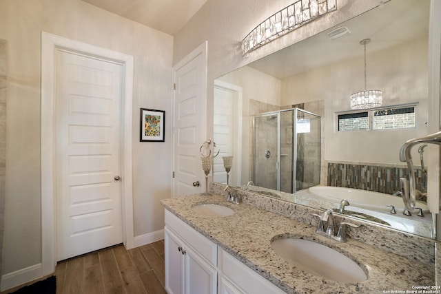 bathroom with wood finished floors, a sink, a garden tub, and a shower stall