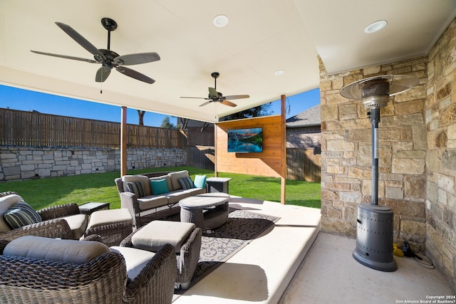 view of patio featuring an outdoor hangout area, a fenced backyard, and a ceiling fan