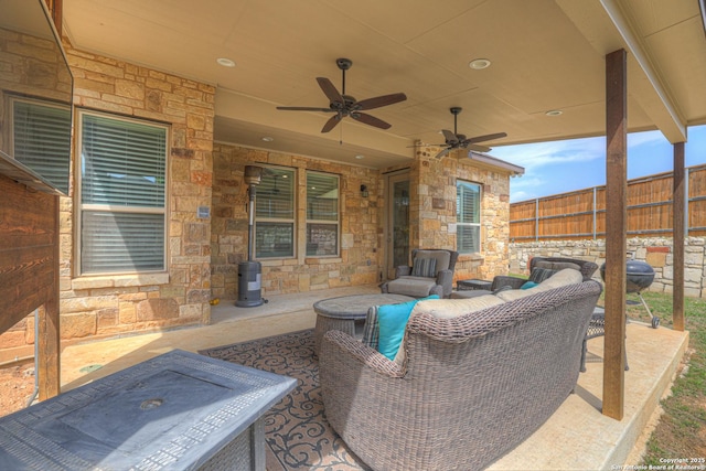 view of patio / terrace featuring ceiling fan and fence